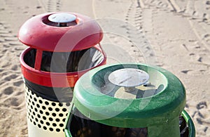 Two trash cans on the beach sunny day