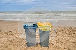 Two trash cans on the beach