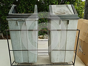 Two Trash Cans in Front of the Garden