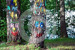 Two tree trunks with funny faces painted. Animated object
