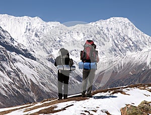 Two trekkers and mount Tilicho