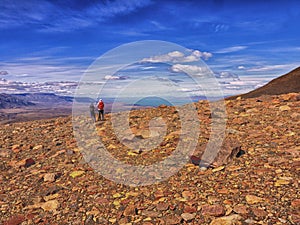 Two trekkers at a rocky viewpoint of Lago Viedma in Patagonia photo