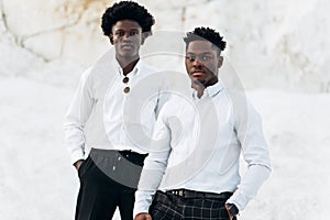 Two trendy black men, fashion portrait of African American male models, in white shirts, outdoors photo