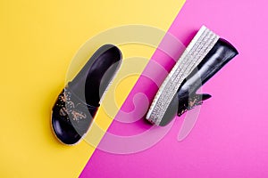 Two trendy female shoes of the same color but different kinds: black loafer and mule. Flat lay
