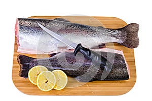 Two trout fishes on wooden plate prepared for lunch