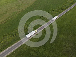 Two Truck with Cargo Semi Trailer Moving on Rural Road in Direction. Aerial Top View