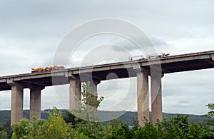 Two Trucks driving on the viaduct.