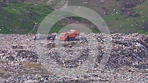Two trucks are dumping garbage. Environmental pollution.