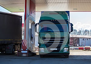 Two trucks at a gas station