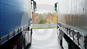 two trucks at a highway rest area