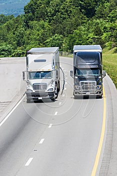 Two Trucks on Interstate Highway Vertical with Copy Space