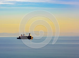 Two tugboats with still water at sunset.