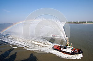 Two tugs spraying water in celebration