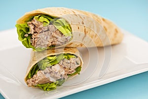 Two tuna melt wrap on a white plate