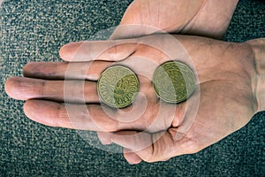Two Tunisian coins on the woman's palm