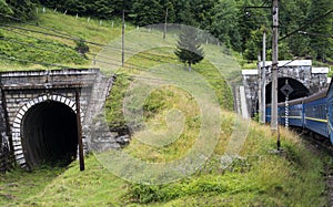 Two tunnels in the Carpathians with entering train