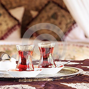 Two turkish tea cups and turkish delight with oriental canopy be