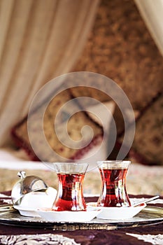 Two turkish tea cups and turkish delight with oriental canopy be