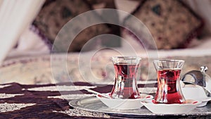 Two turkish tea cups and turkish delight with oriental canopy be