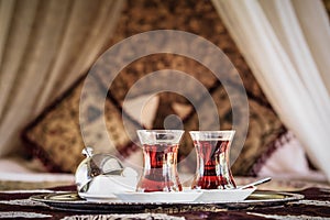 Two turkish tea cups and turkish delight with oriental canopy be