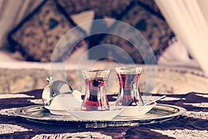 Two turkish tea cups and turkish delight with oriental canopy be