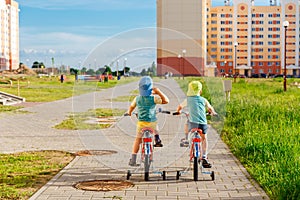 Two Twin Brothers Riding Bikes Together