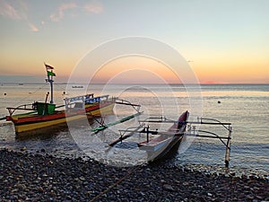 Two type of fishing boats mooring on the beach in afternoon