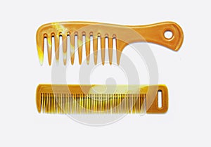 Two types of brown wood combs for hair styling or hair sets for both men and women with long hair, white background