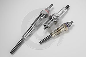 Two types of glow plug and spark plug on a white background. 3d rendering
