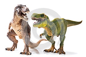 Two Tyrannosaurus Rex figurines on white