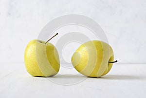 Two ugly misshapen golden fresh apples