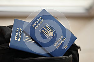 Two ukrainian biometrical passports on black touristic backpack