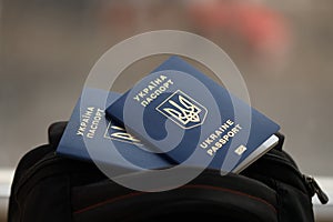 Two ukrainian biometrical passports on black touristic backpack