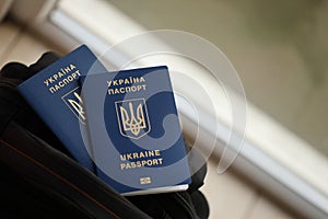 Two ukrainian biometrical passports on black touristic backpack