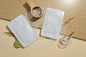 Two unbranded mask sheets are displayed on a table with rice bran. Rice bran contains Gamma-oryzanol with skin beautifying effects