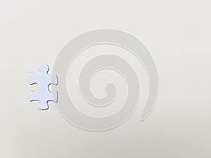 A puzzle piece on white background. Problem solving, teamwork and the integration of different elements