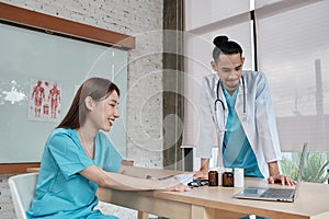 Two uniformed young doctors work in medical clinic office