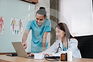 Two uniformed young doctors work in medical clinic office