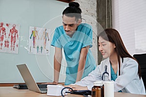 Two uniformed young doctors work in medical clinic office