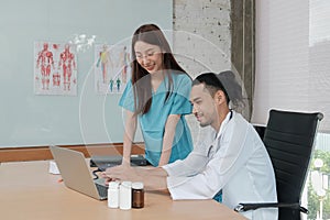 Two uniformed young doctors work in medical clinic office