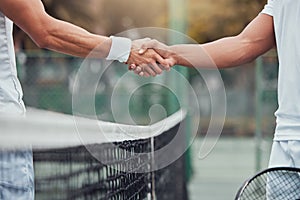 Two unknown ethnic tennis players shaking hands before playing court game. Fit athletes team standing and using hand