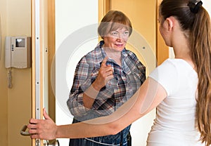 Two unpleased women at doorway