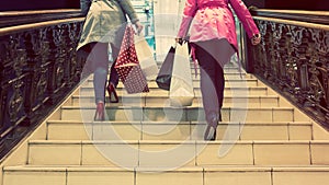 Two unrecognisable young female friends enjoying a day out shopping