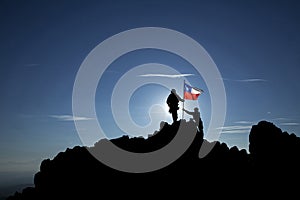 Two unrecognizable  soldiers raise the Chilean flag