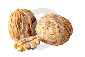 Two unshelled walnuts and walnut halve isolated on white