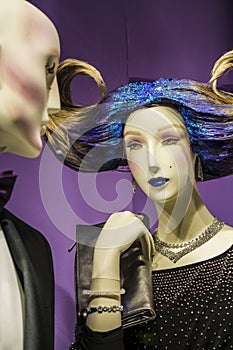 Two unusual dummies and original hairstyle. The girl with blue hair and in a black dress. Modern fashion.