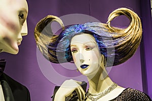Two unusual dummies and original hairstyle. The girl with blue hair and in a black dress. Modern fashion.