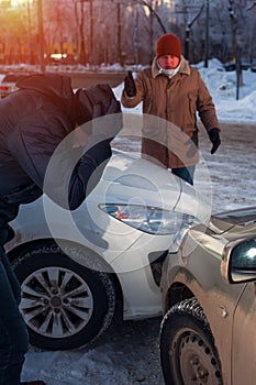 Two upset men after car crash on city street