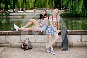 Two urban teen girls posing in park