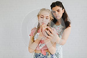 Two urban teen girls posing in a vintage room